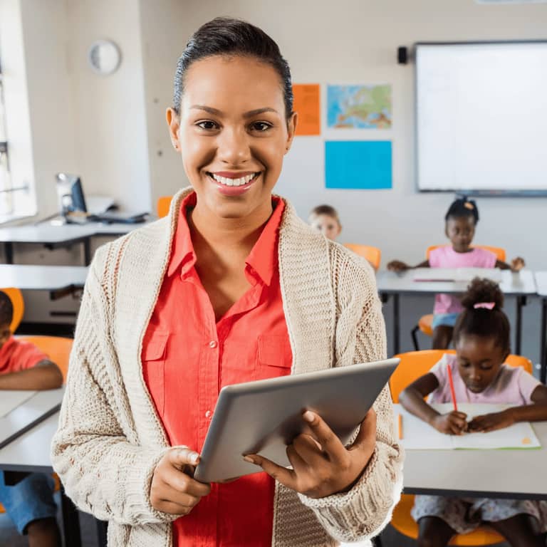 Educator smiling in a classroom setting