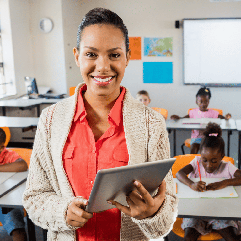 Educator smiling in a classroom setting